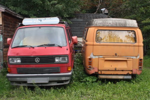 A second-generation Microbus (right) reverts back to nature alongside a 1980s-vintage Vanagon in Ottawa, Ontario.