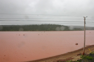 Iron oxide turns a lake blood-red near the Mont Wright iron mine, just west of Fermont, Quebec.
